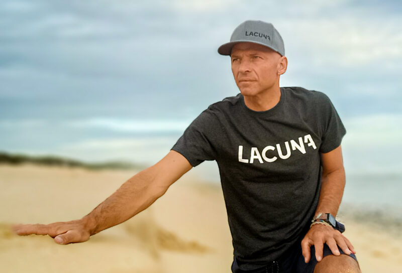 Cedric Vandenschrik with Lacuna T shirt and Cap on a beach